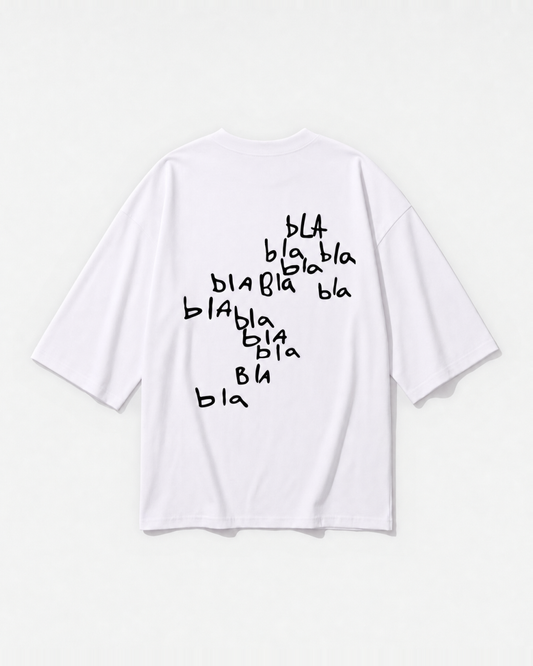 Scribbled 'bla bla bla' graphic printed across the back of a white oversized t-shirt by Dear India