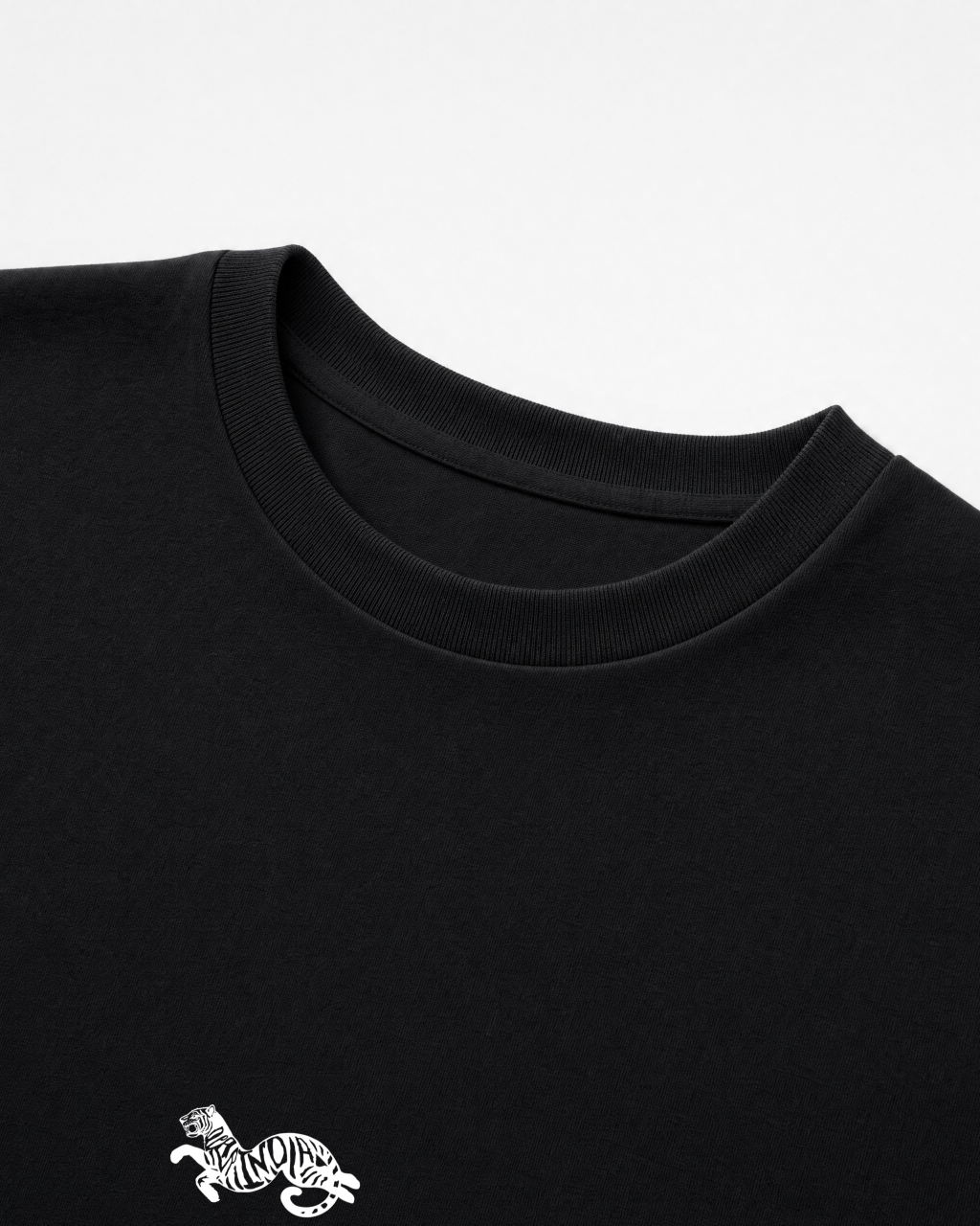 Close-up of the ribbed crew collar on the black Dear India oversized t-shirt