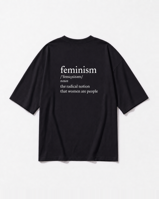 The dictionary definition of feminism printed across the back of a black oversized t-shirt by Dear India