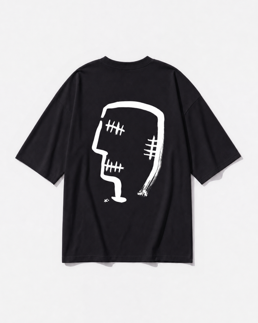 Gandhi's three wise monkeys reworked as one graphic printed across the back of a black oversized t-shirt by Dear India