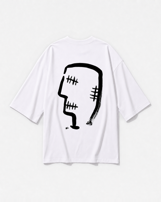 Gandhi's three wise monkeys reworked as one graphic printed across the back of a white oversized t-shirt by Dear India