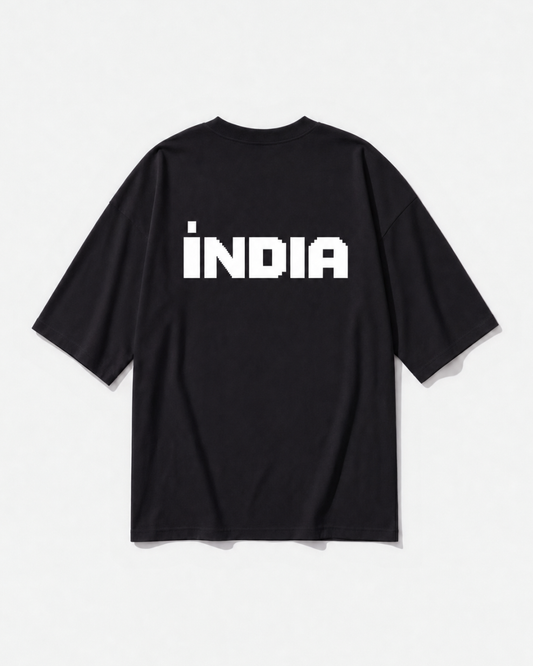 A block-type INDIA wordmark printed across the back of a black oversized t-shirt by Dear India