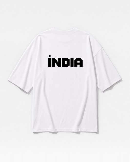 A block-type INDIA wordmark printed across the back of a white oversized t-shirt by Dear India