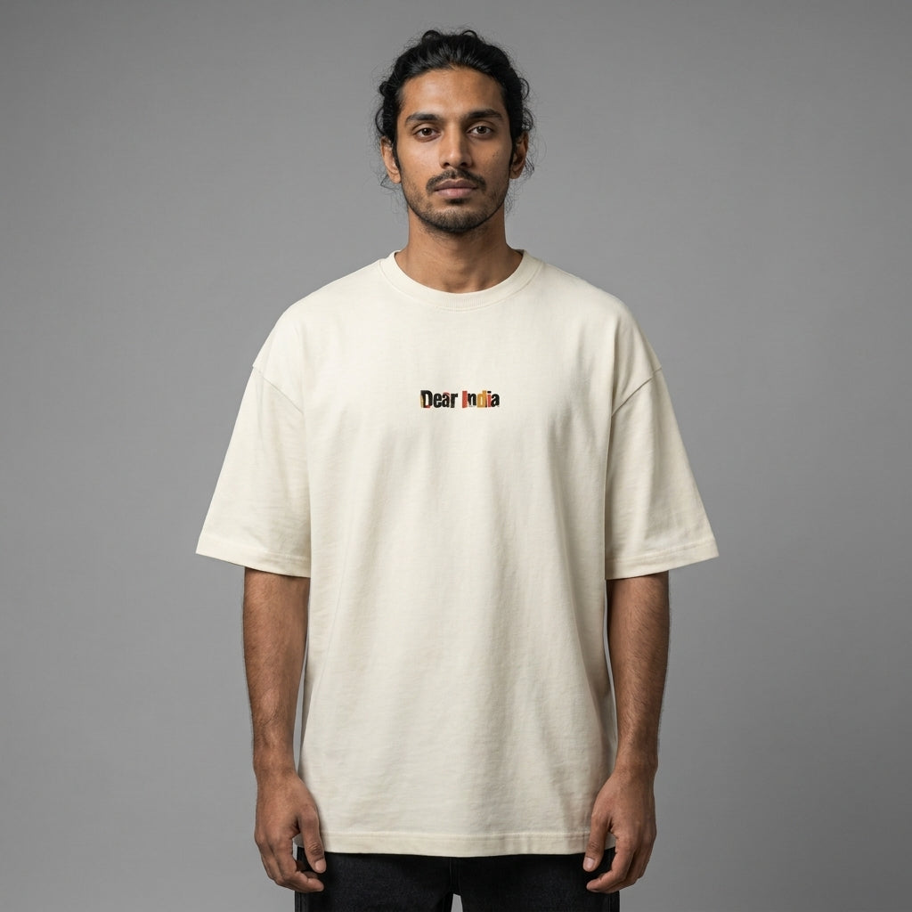 Man wearing a beige t-shirt with 'Dear India' text on a gray background