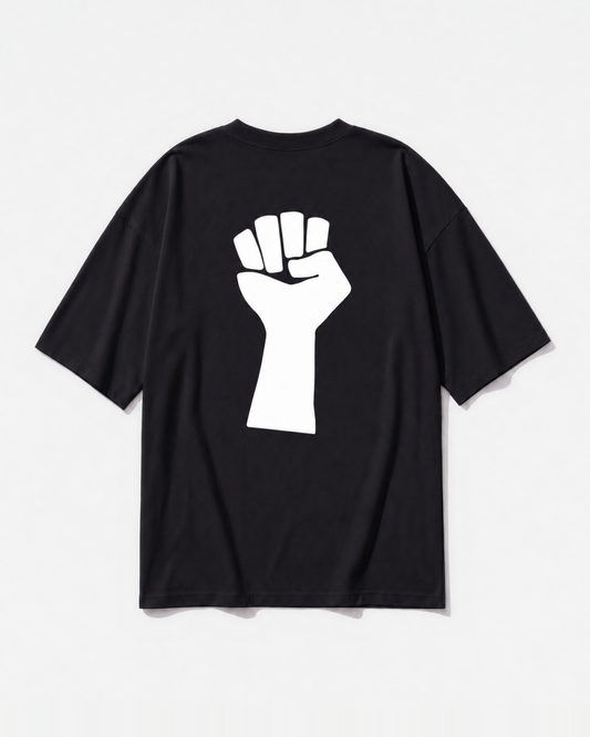 A raised fist graphic printed across the back of a black oversized t-shirt by Dear India