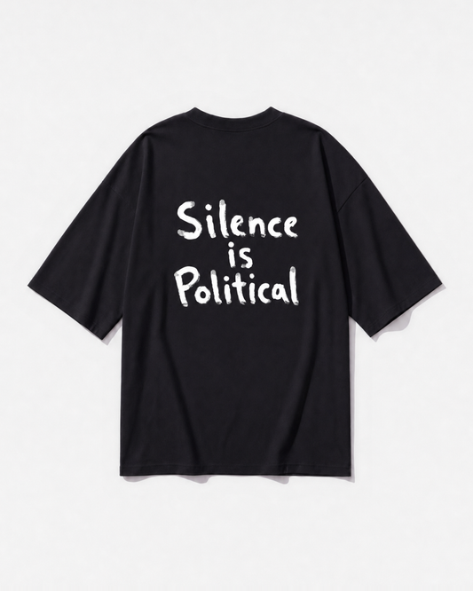 A 'Silent Politics' statement graphic printed across the back of a black oversized t-shirt by Dear India