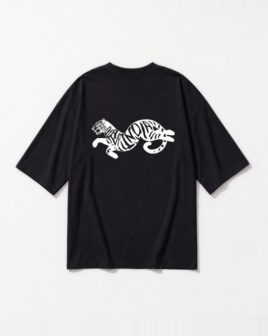 The Dear India tiger mid-leap with lettered stripes printed across the back of a black oversized t-shirt
