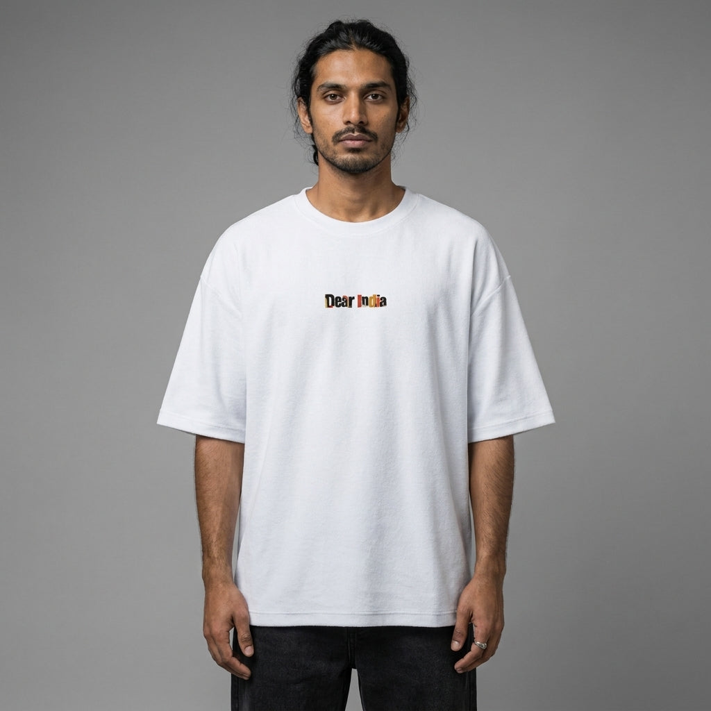 Man wearing a white t-shirt with a logo on a gray background