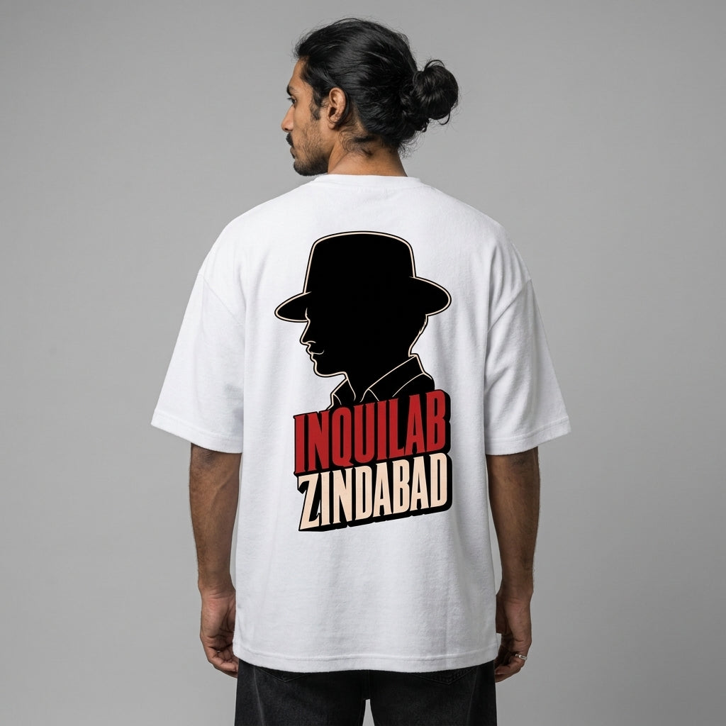 Person wearing a white t-shirt with a graphic design on the back against a gray background