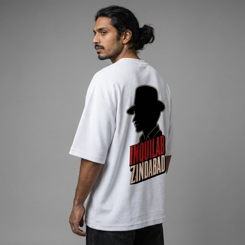 Man wearing a white t-shirt with a graphic design on the back against a gray background