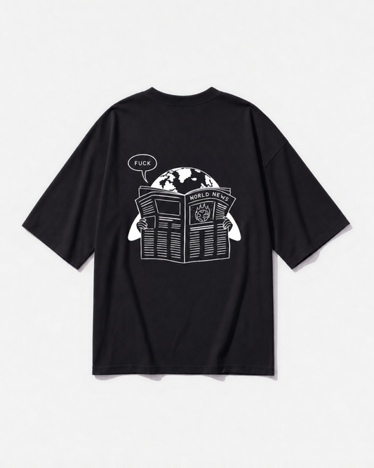 A newspaper-style 'World News' graphic printed across the back of a black oversized t-shirt by Dear India